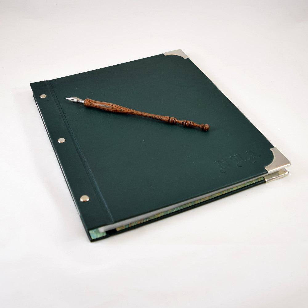 leather portfolio album displayed with turned wood calligraphy pen