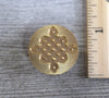 closeup of celtic knot brass seal