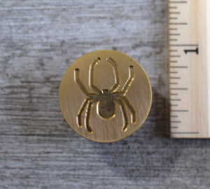 closeup of spider brass stamp head